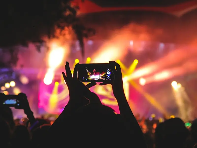 Fan recording a live jam session at a concert